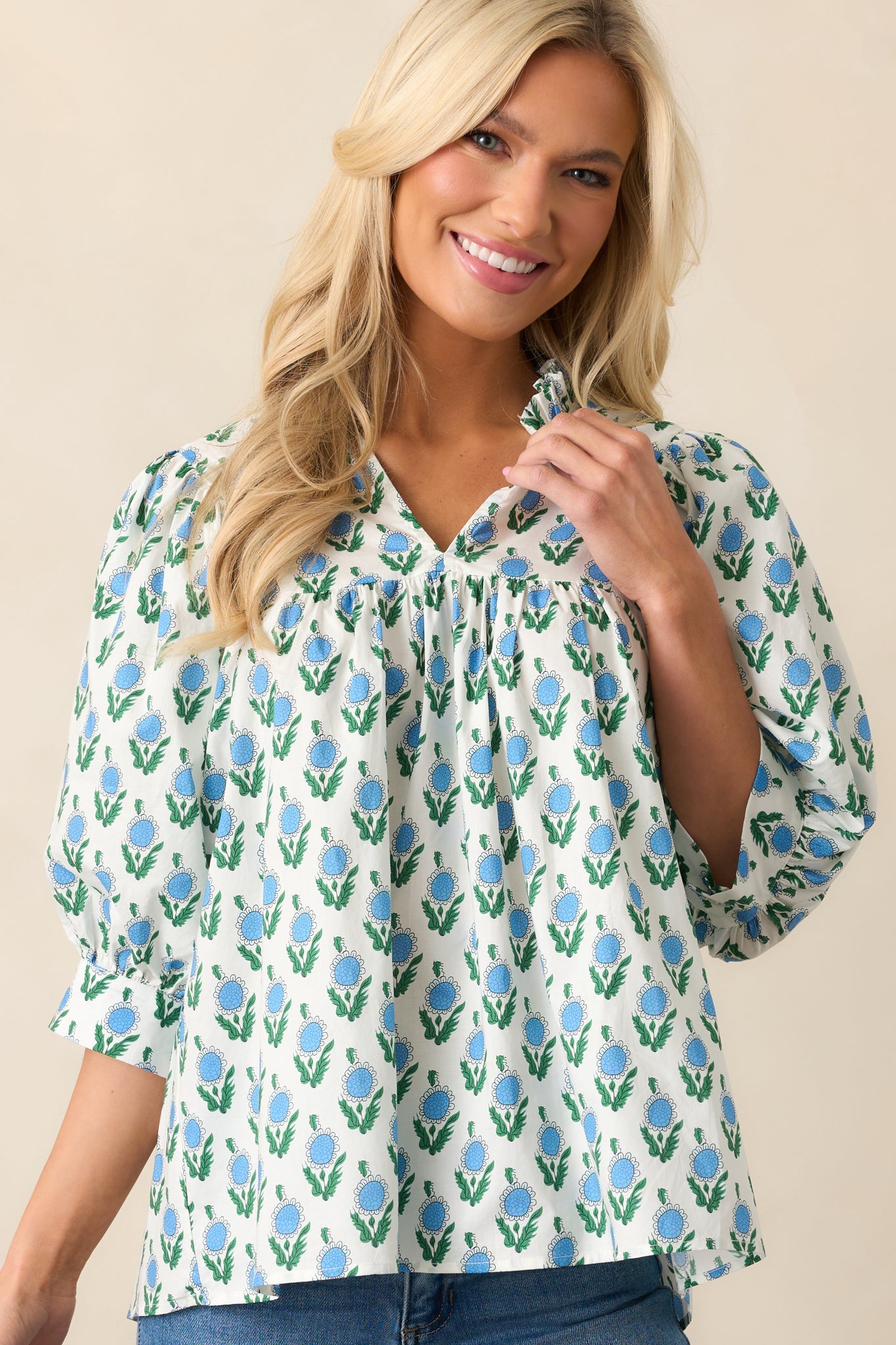 A midsection view of the blue top, emphasizing the flow of the fabric and detailed floral print.