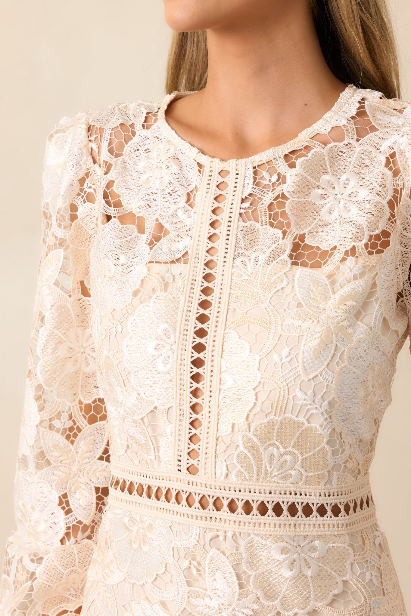 A detailed look at the embroidered floral overlay, emphasizing the fine stitching and intricate pattern.