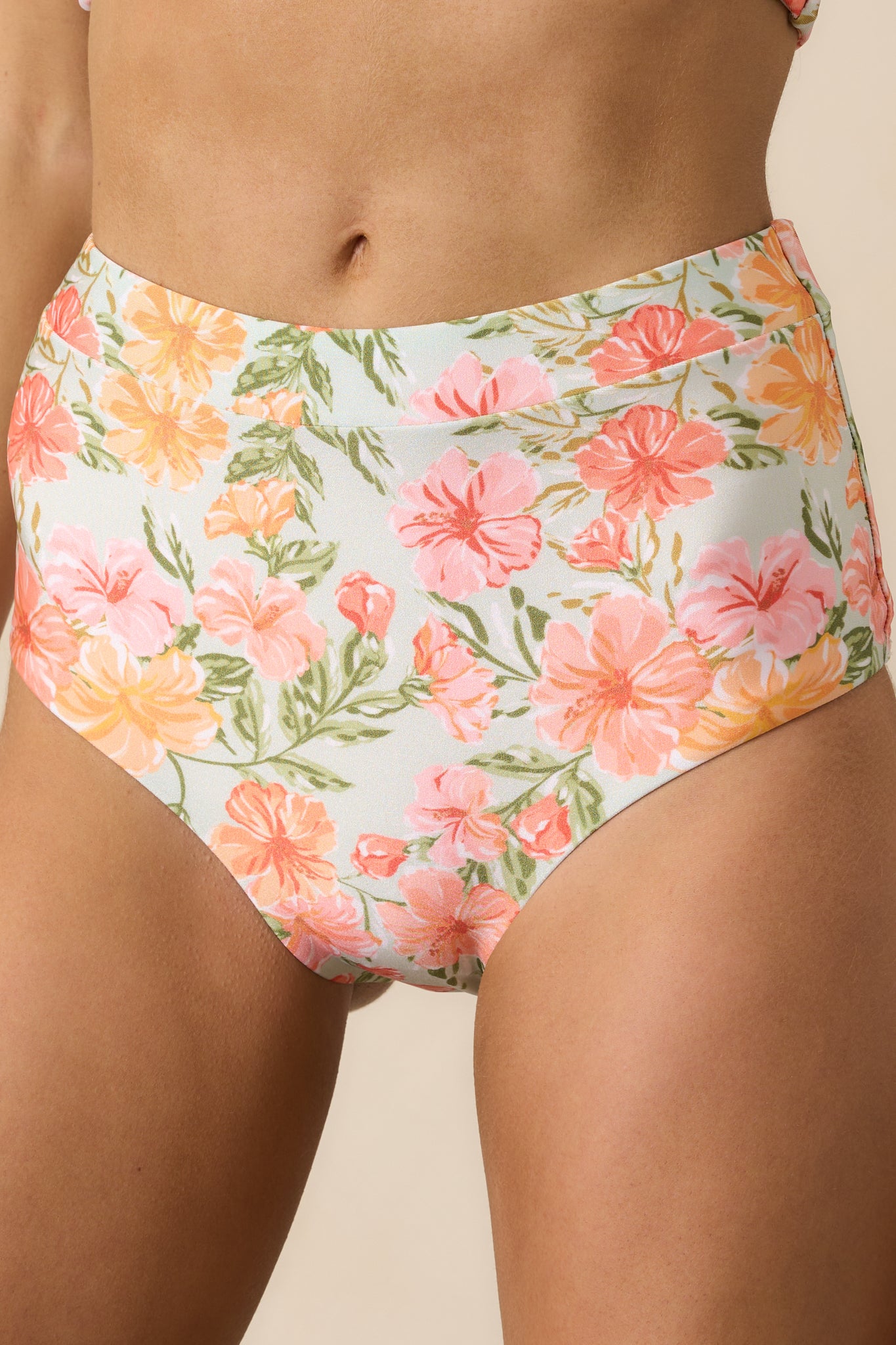 A close-up of the tropical floral print on the pink bikini bottoms, highlighting the vibrant colors and intricate pattern for a fun beach-ready style.
