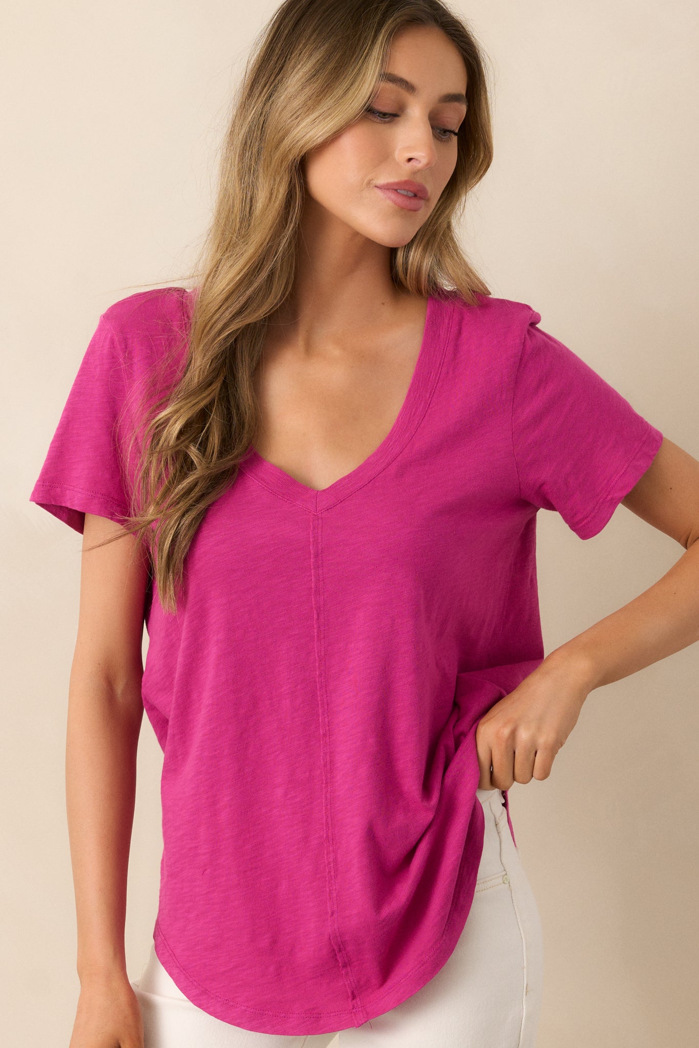Focused on the v-neckline and fabric texture of the magenta top, showcasing the soft cotton slub material and flattering center seams.