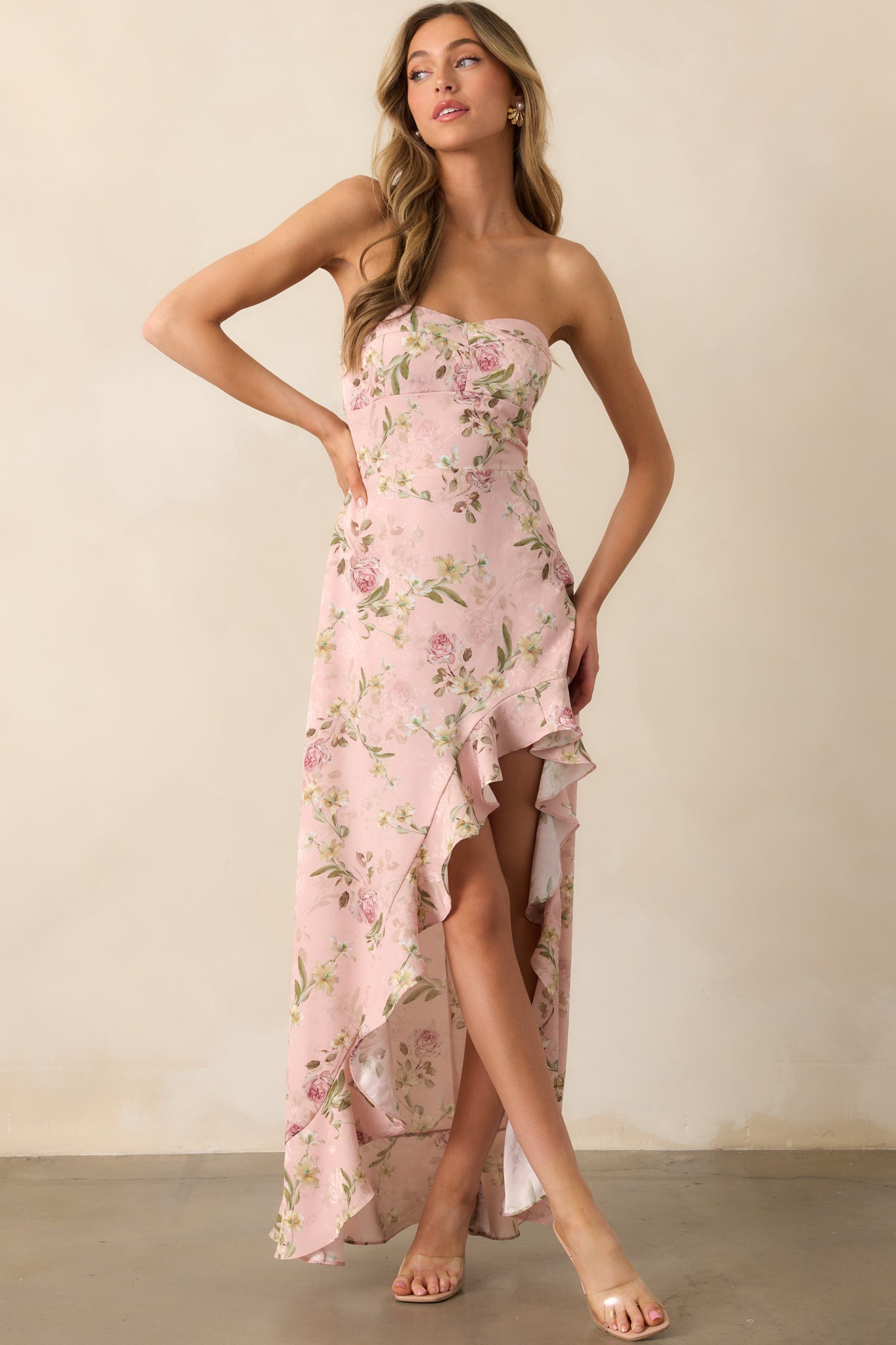 This light pink strapless dress features a sleek neckline with non-slip strips along the interior hem, ensuring a secure fit. The back smocked panels provide stretch, and the high-low asymmetrical bottom hem adds a modern, flowing touch.
