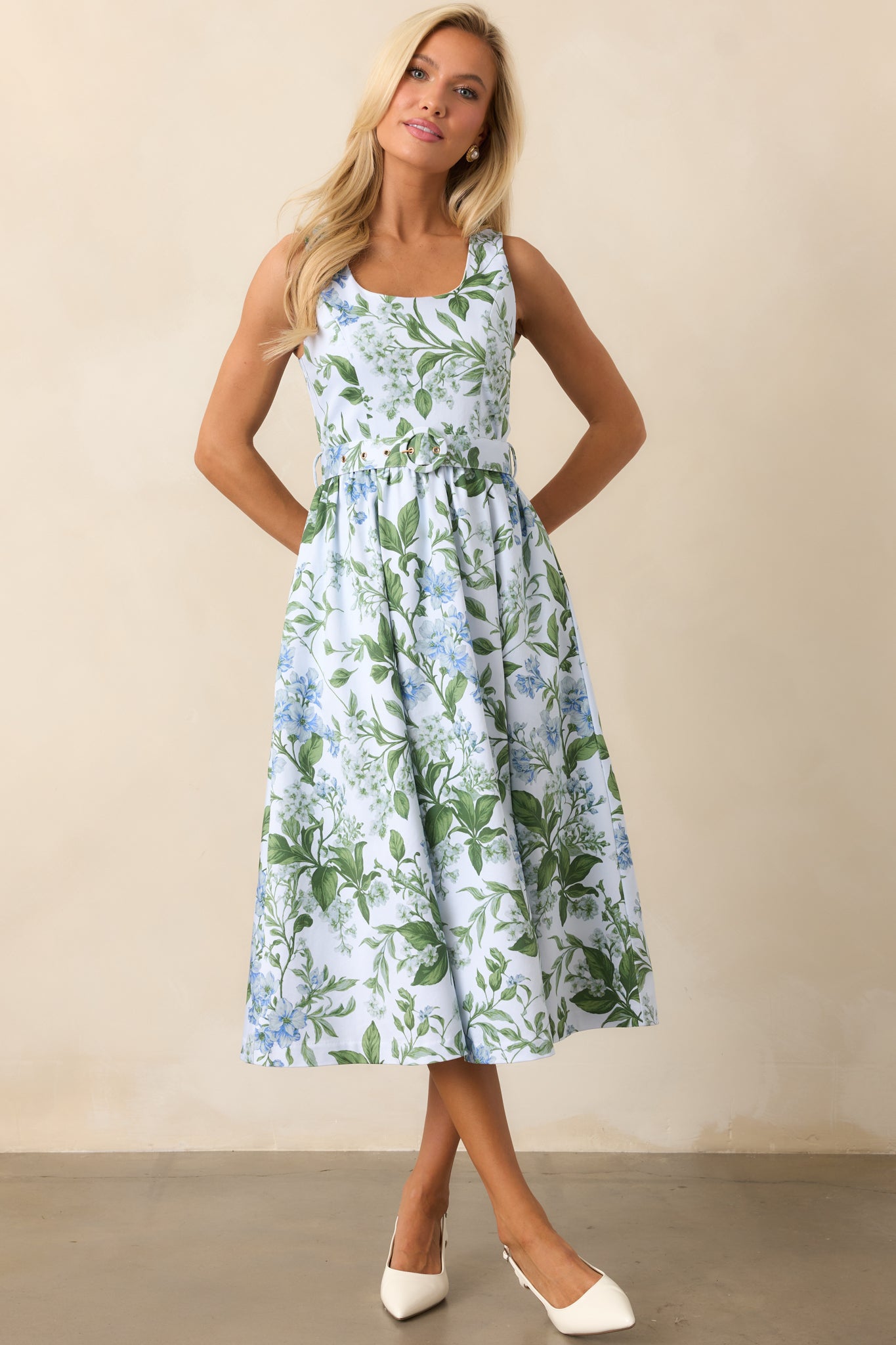 A charming blue midi dress with a delicate lilac botanical print, a flattering scoop neckline, and a relaxed fit.