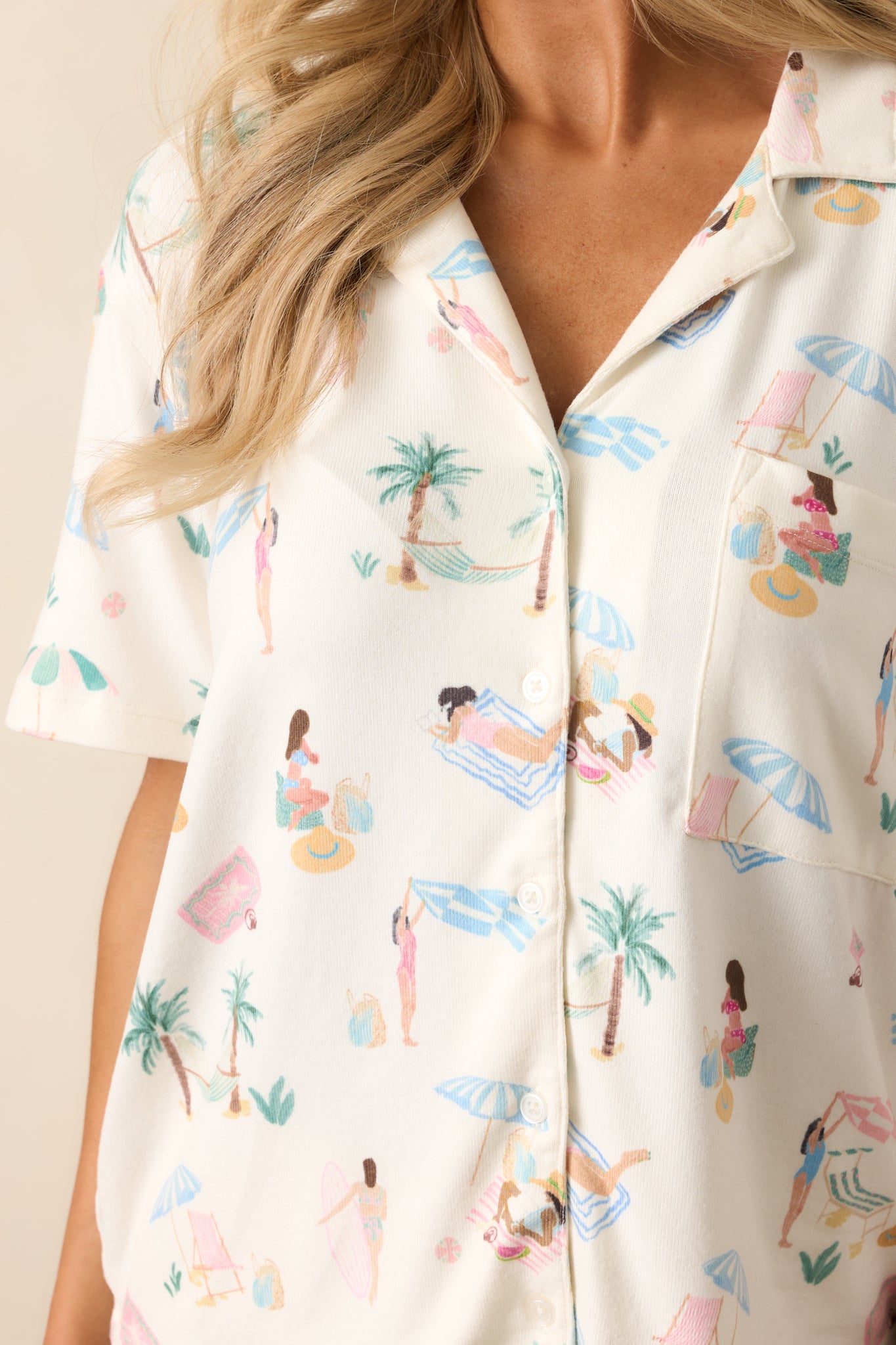 A close-up of the pajama top’s ultra-soft jersey fabric, highlighting the intricate beach print and precise stitching along the lapels and pocket.