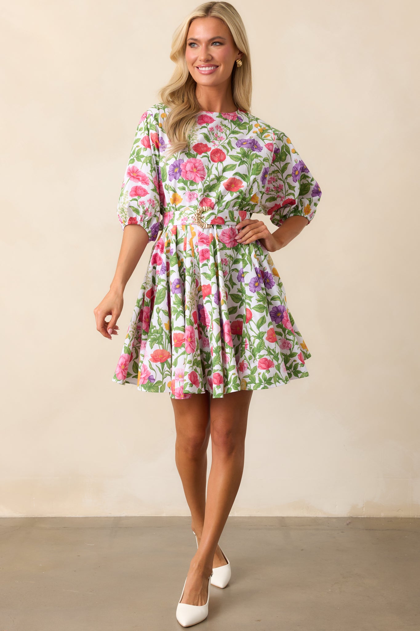 A floral mini dress with a round neckline and fit-and-flare swing silhouette, displayed in a full-length view.