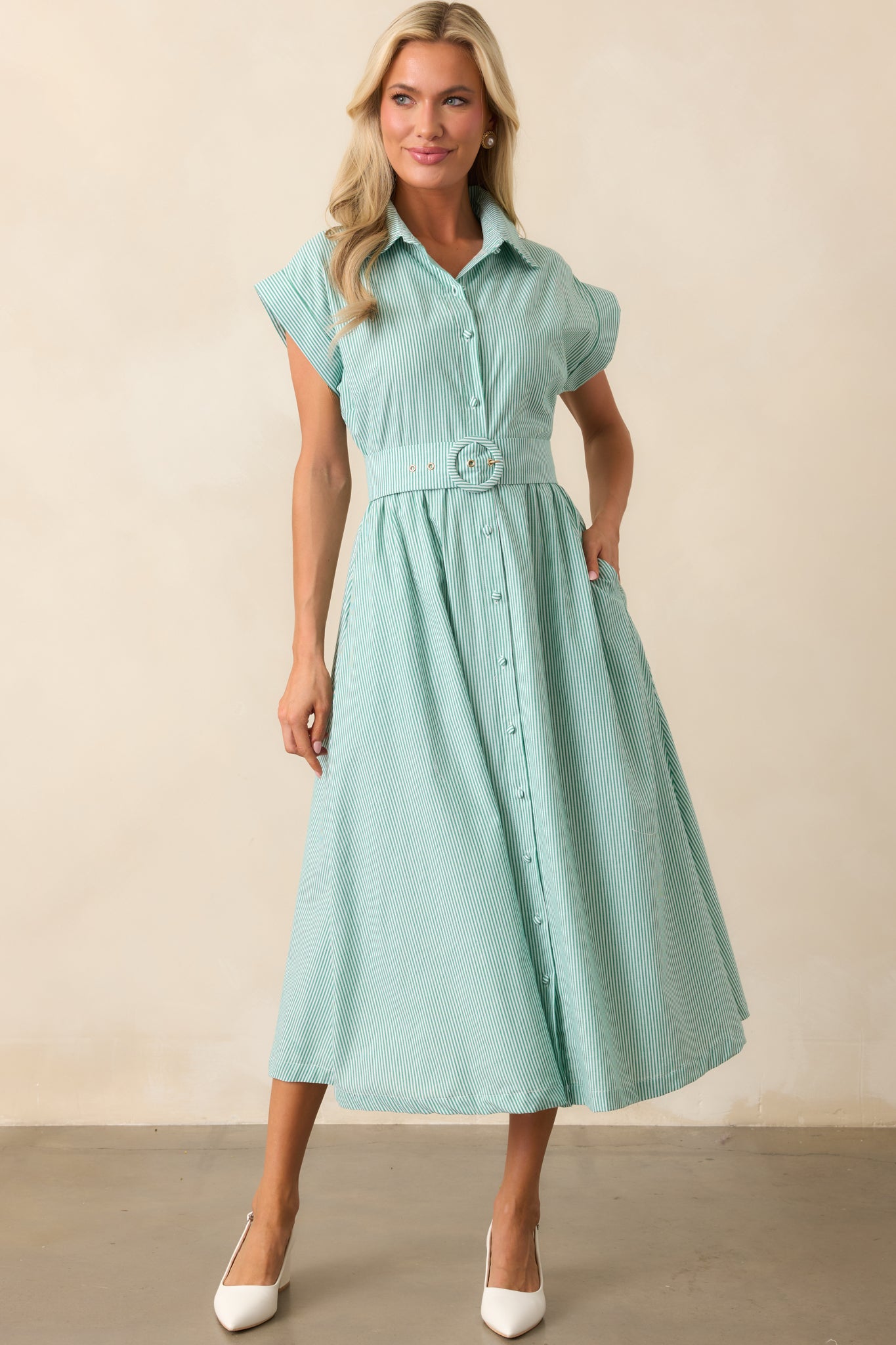 A full-length image of the dress, focusing on its cuffed short sleeves and tailored design.