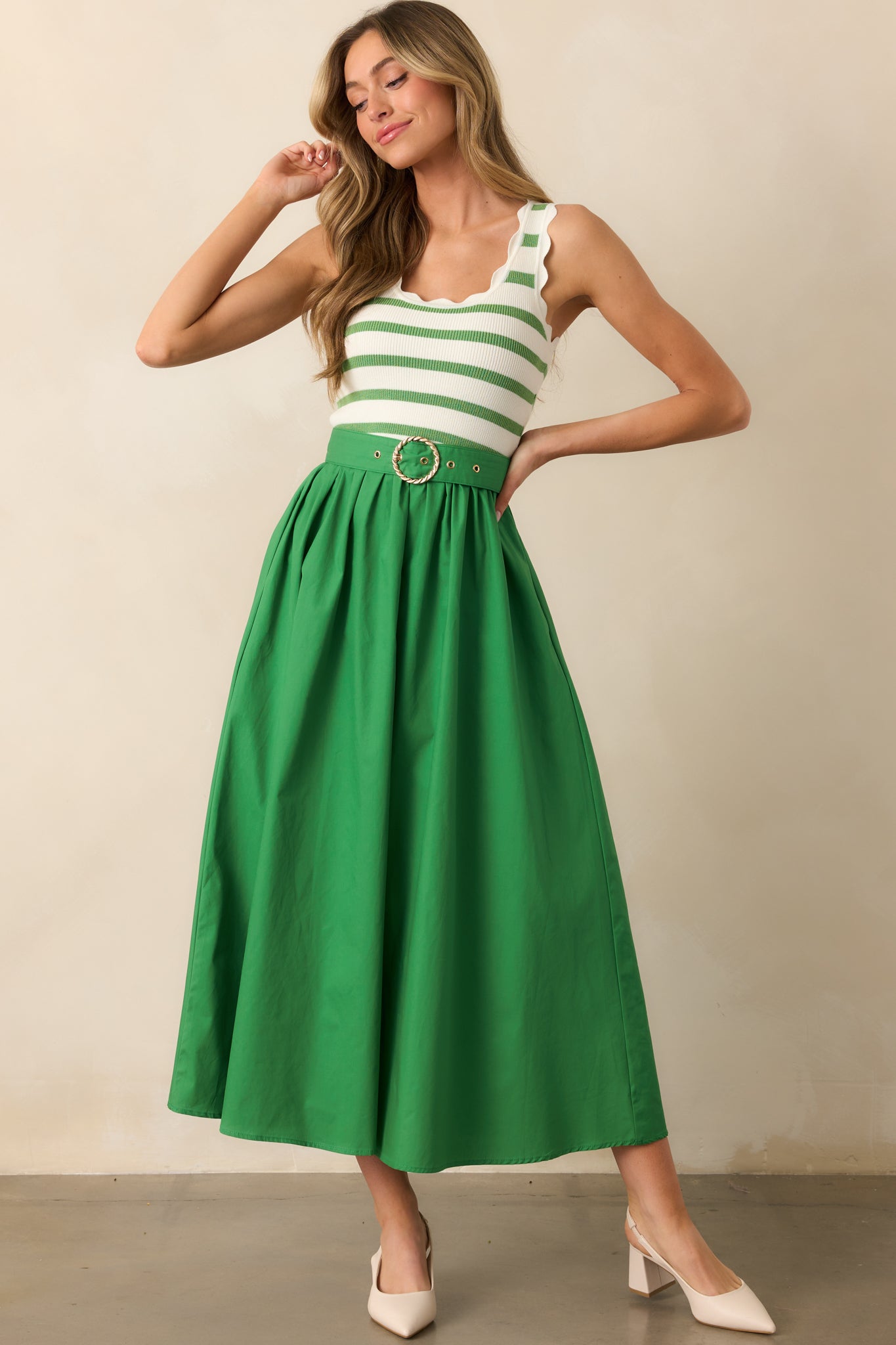 Green midi dress with a striped knit top and scalloped hems, creating a charming and unique contrast.